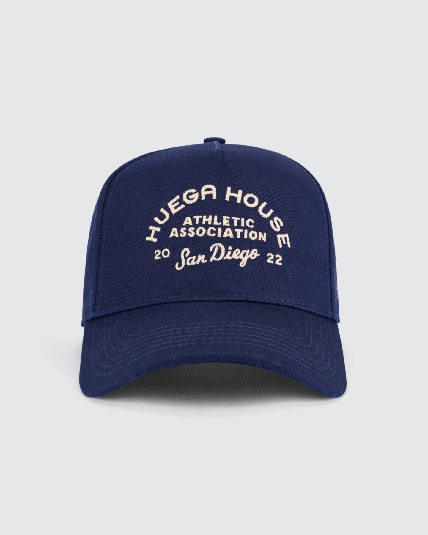 Navy blue cap with white text on a light gray background