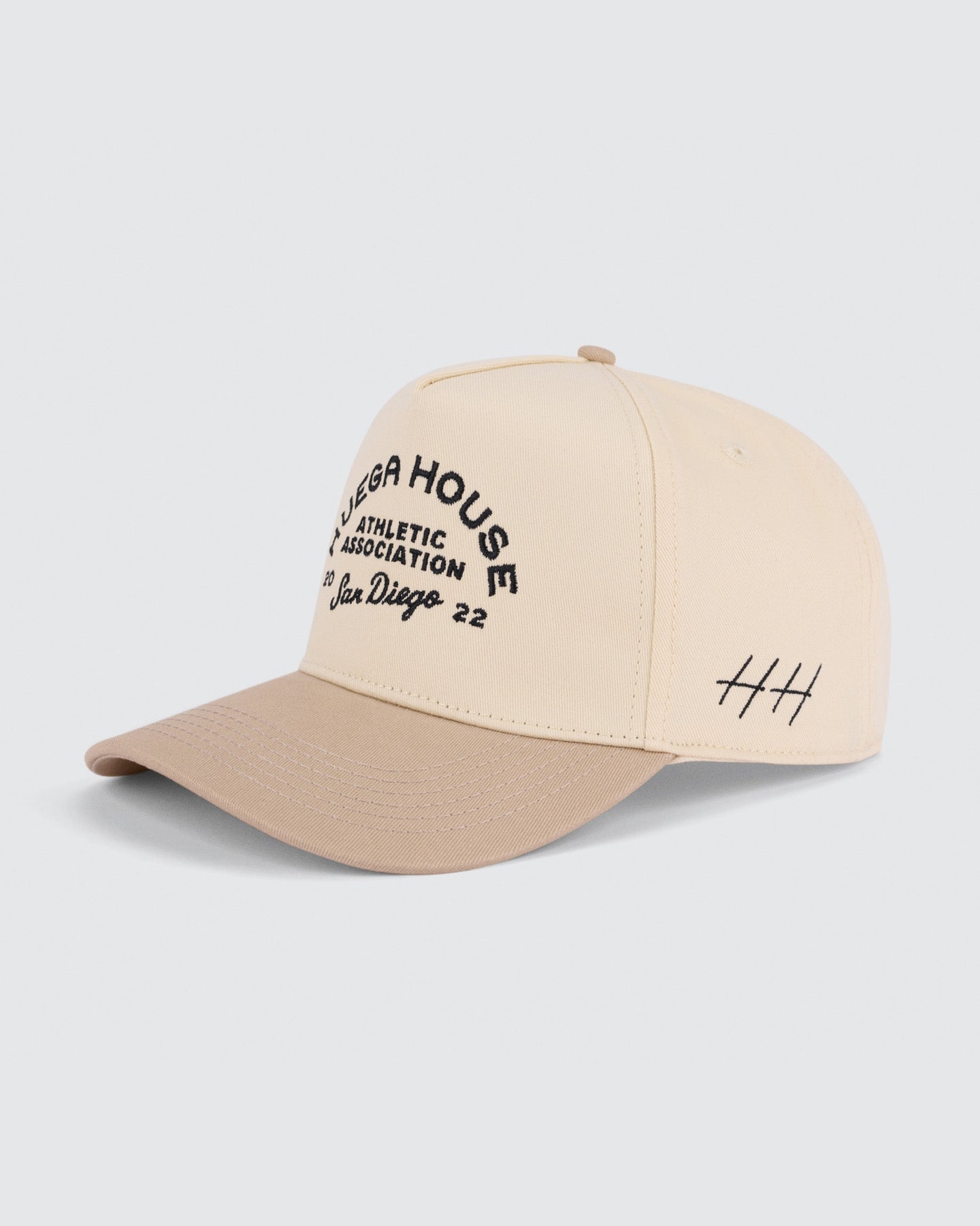 Beige cap with text and logo on a light gray background