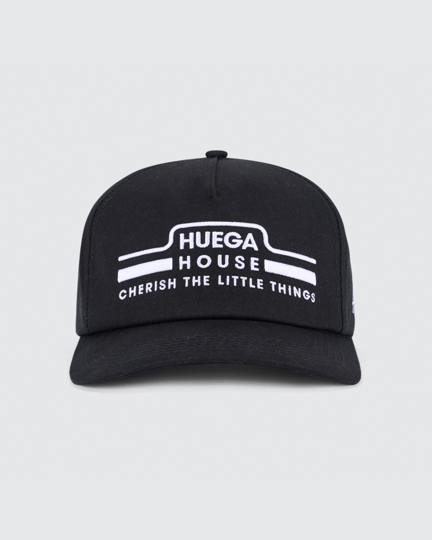 Black cap with white text on a light gray background