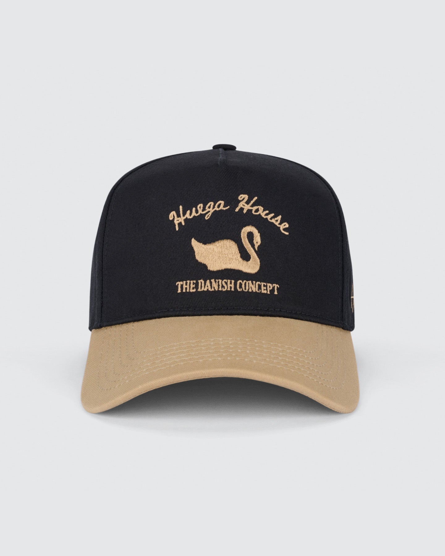 Black and beige cap with 'Huega House' logo on a light gray background. Vintage Swan | Khaki & Black Hat by Huega House