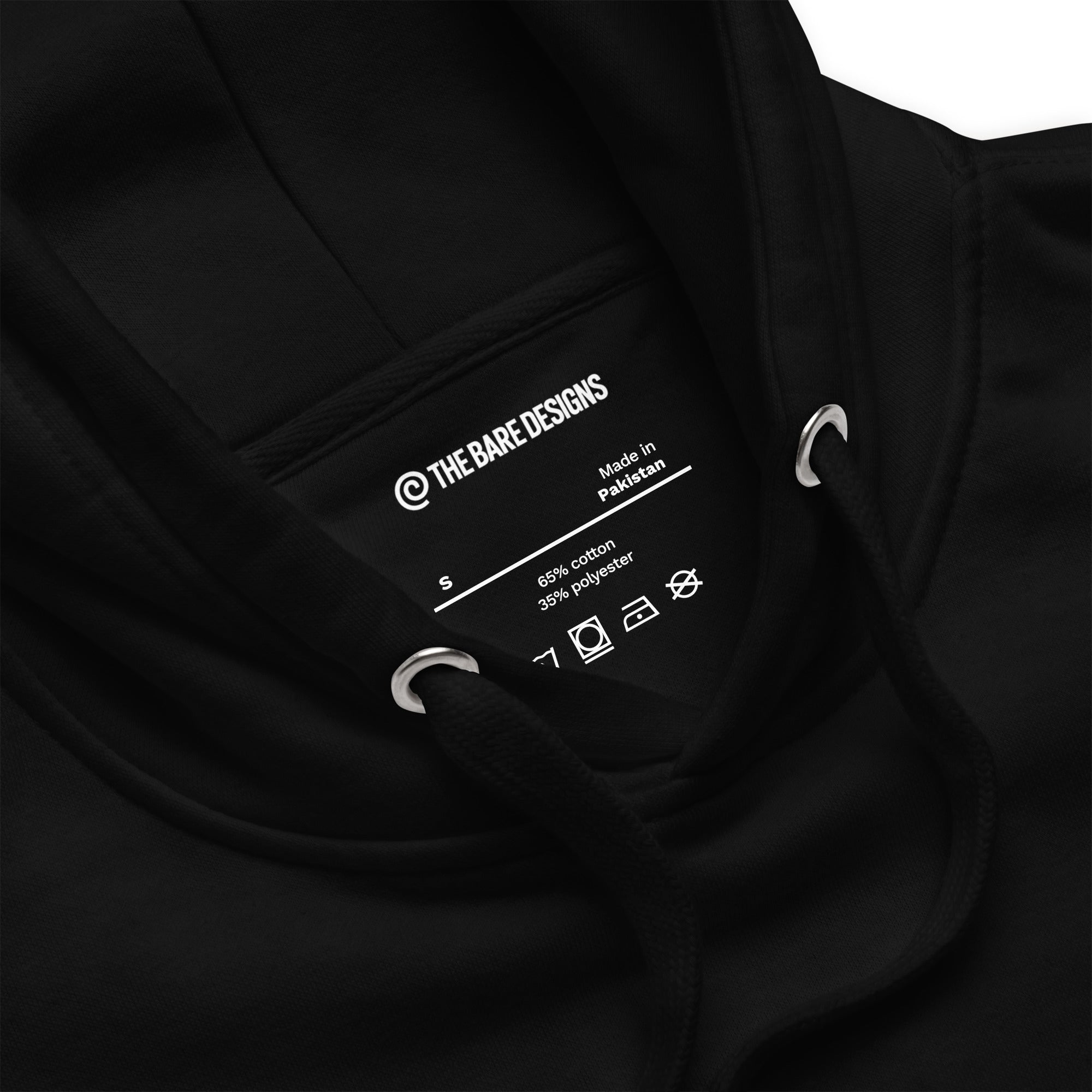 Black hoodie with brand label and care instructions on a white background.  The brand - The bare designs