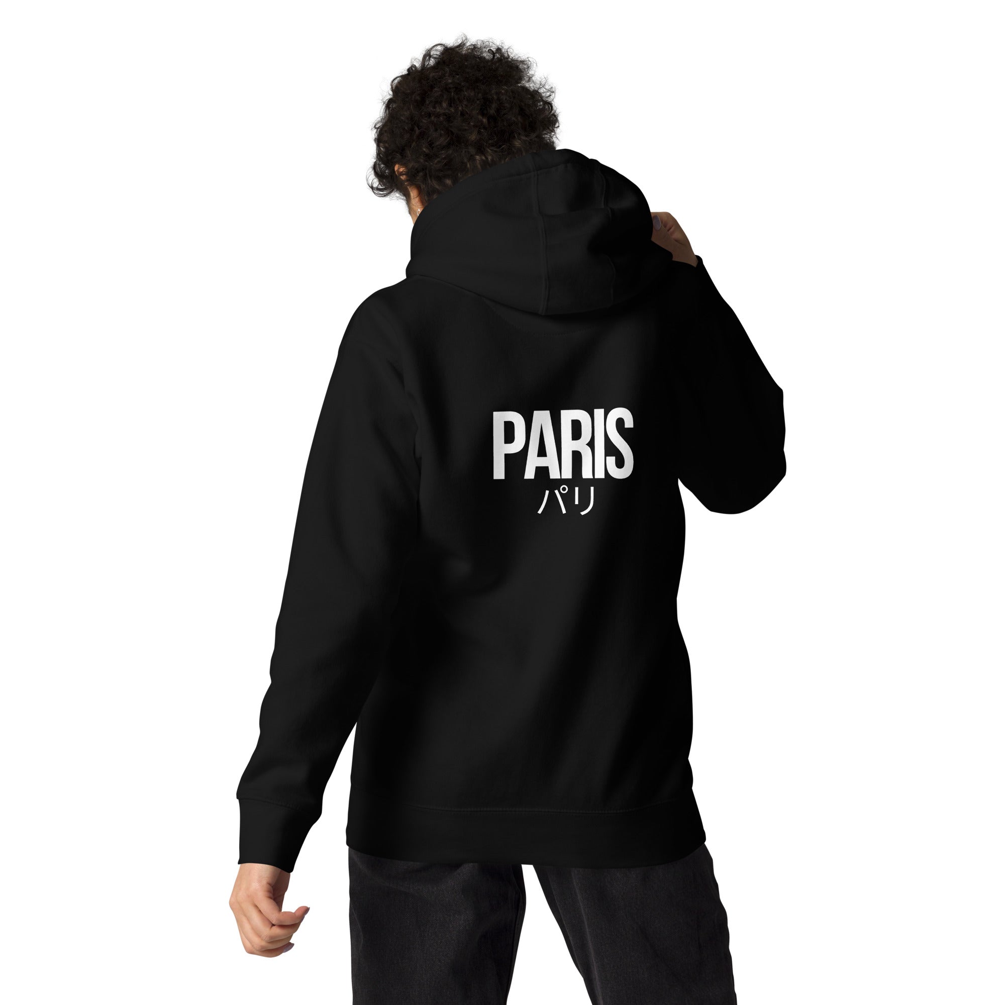 Person wearing a black hoodie with a PARIS design on the back, against a white background