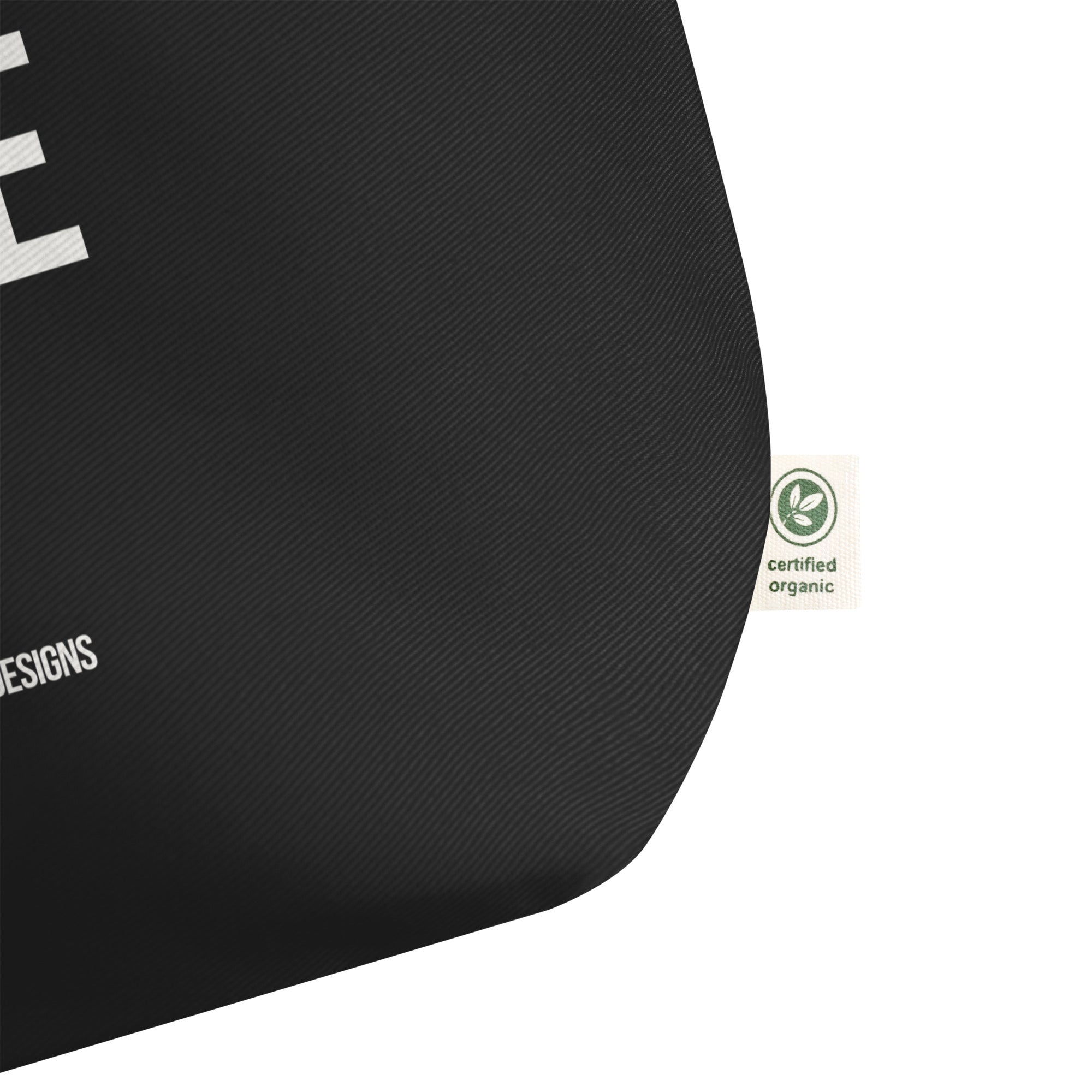 Black tote bag with a certified organic label on a white background